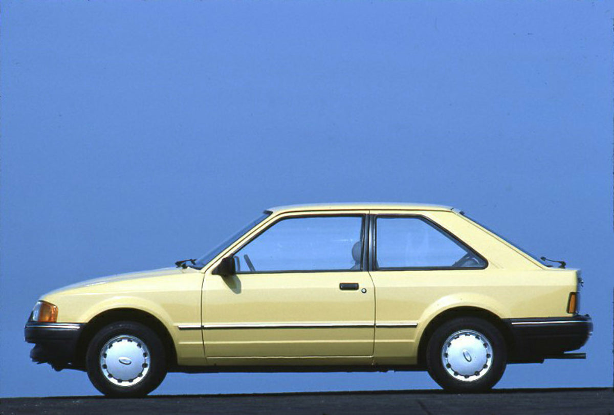 This archival image documents the 1986 Ford Escort Mark IV CL side view with scenic blue sky and is preserved in the Ford Heritage Vault as part of Ford Motor Company's historic photographic archive. Free for personal, non-commercial use. Ford Her...