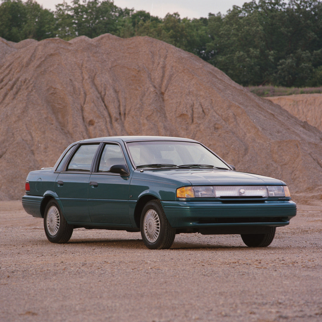 This archival image documents the 1993 Mercury Topaz with Sand Pile in Background and is preserved in the Ford Heritage Vault as part of Ford Motor Company's historic photographic archive. Free for personal, non-commercial use. Ford Heritage Vault...