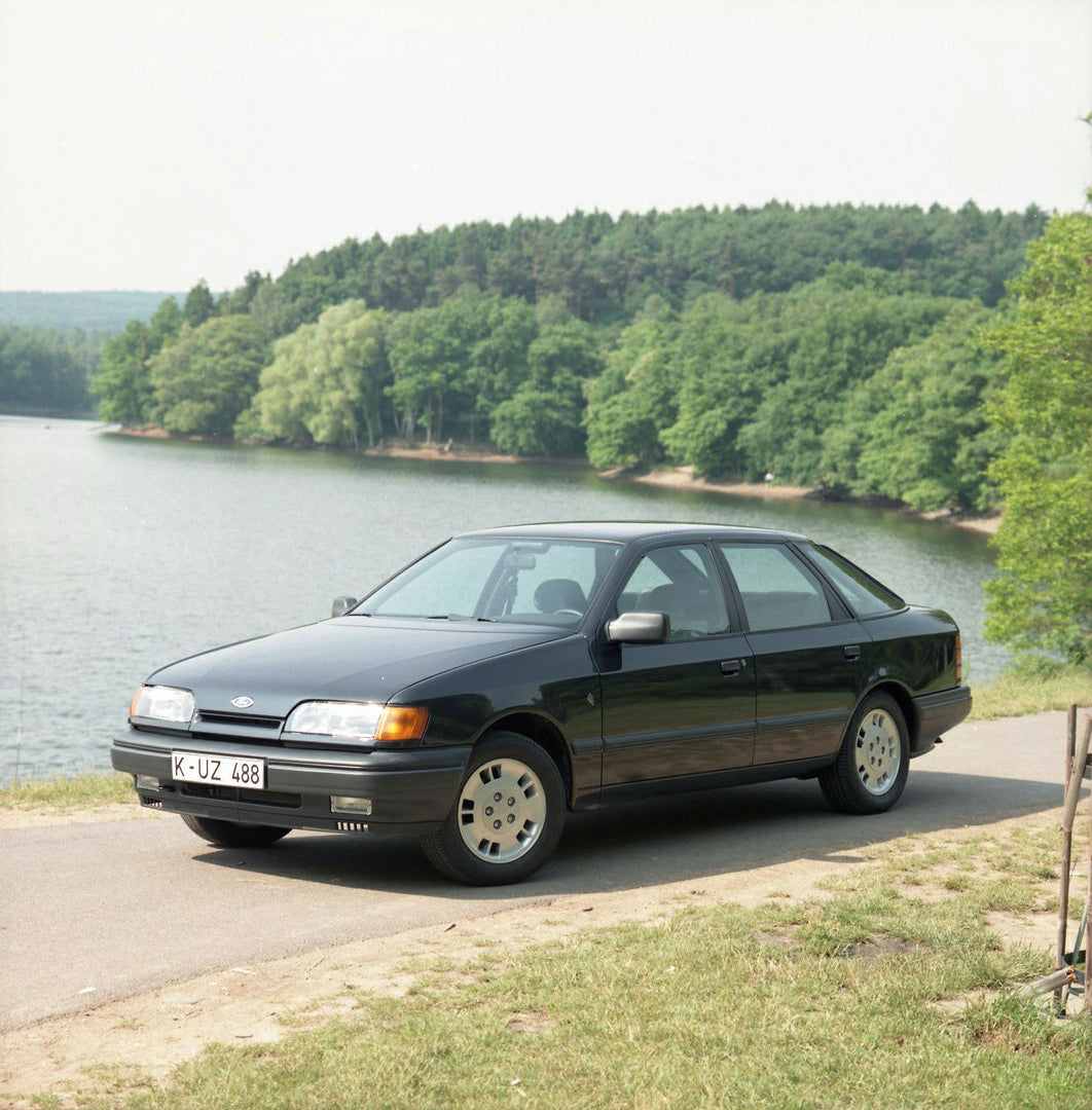 This archival image documents the 1985 Ford Scorpio Mark I 4 Wheel Drive LHD on scenic road with lake and is preserved in the Ford Heritage Vault as part of Ford Motor Company's historic photographic archive. Free for personal, non-commercial use....