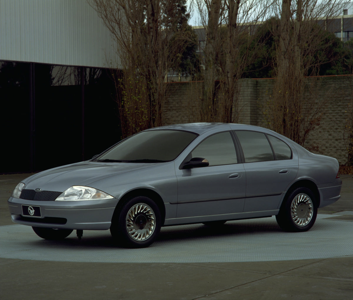 This archival image documents the 1998 Ford Falcon with scenic trees and brick wall and is preserved in the Ford Heritage Vault as part of Ford Motor Company's historic photographic archive. Free for personal, non-commercial use. Ford Heritage Vau...