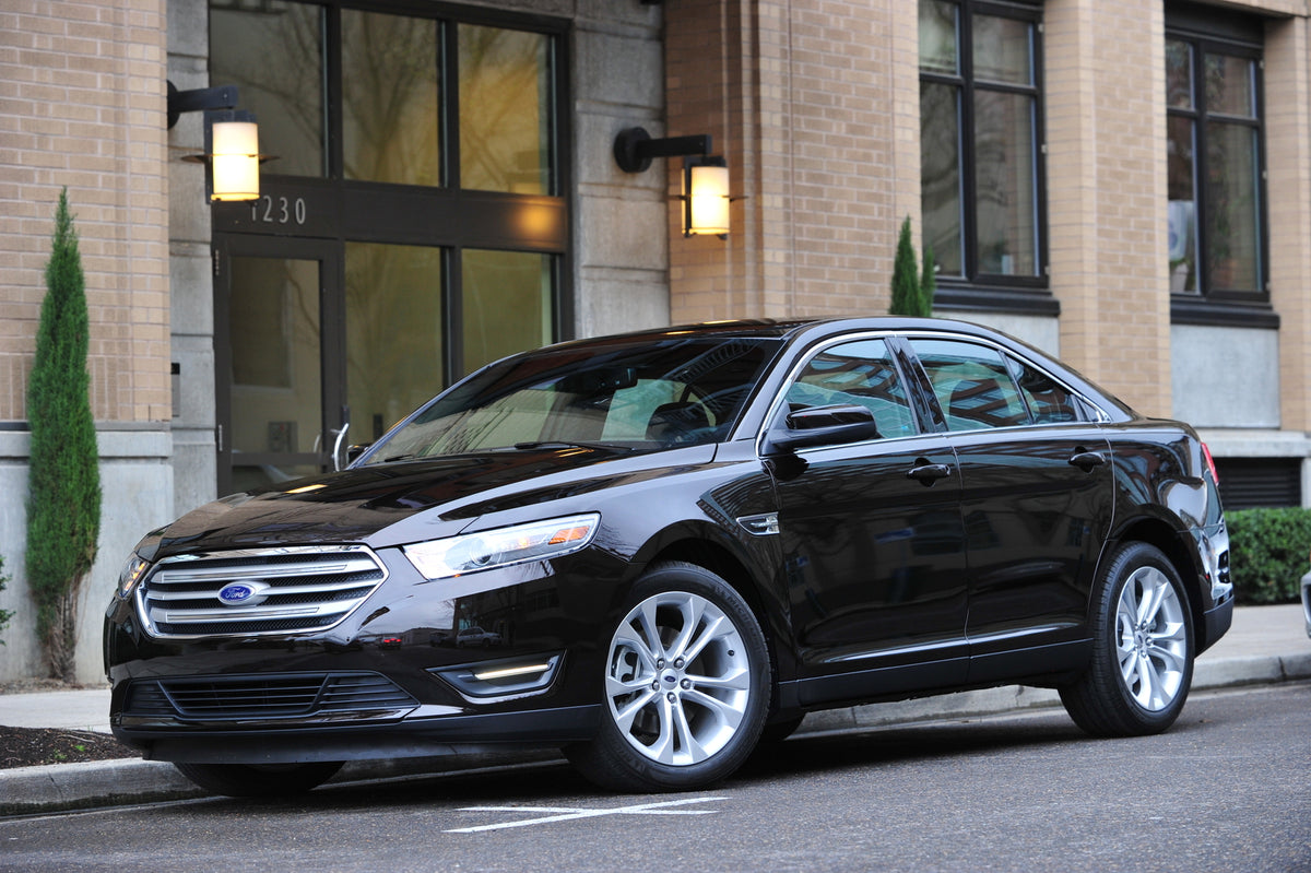This archival image documents the 2013 Ford Taurus in front of brick building and is preserved in the Ford Heritage Vault as part of Ford Motor Company's historic photographic archive. Free for personal, non-commercial use. Ford Heritage Vault ref...