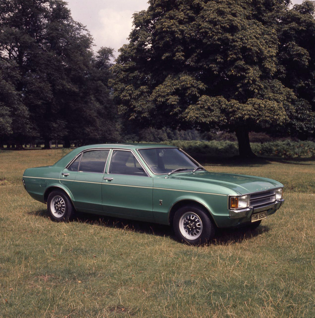 This archival image documents the 1973 Ford Consul L in scenic field with trees and is preserved in the Ford Heritage Vault as part of Ford Motor Company's historic photographic archive. Free for personal, non-commercial use. Ford Heritage Vault r...