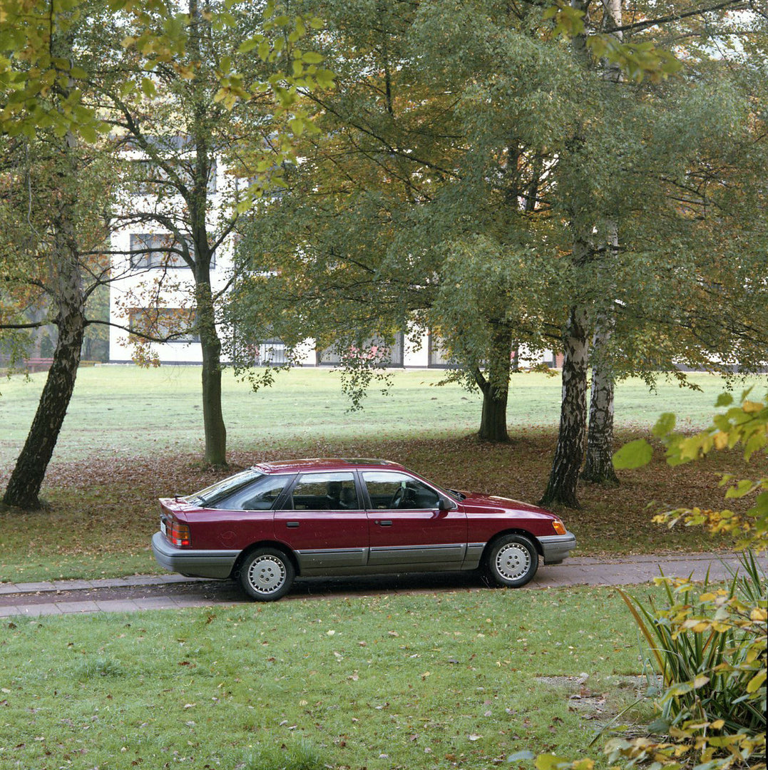 This archival image documents the 1986 Merkur Scorpio rear aerial view on scenic road in Cologne and is preserved in the Ford Heritage Vault as part of Ford Motor Company's historic photographic archive. Free for personal, non-commercial use. Ford...
