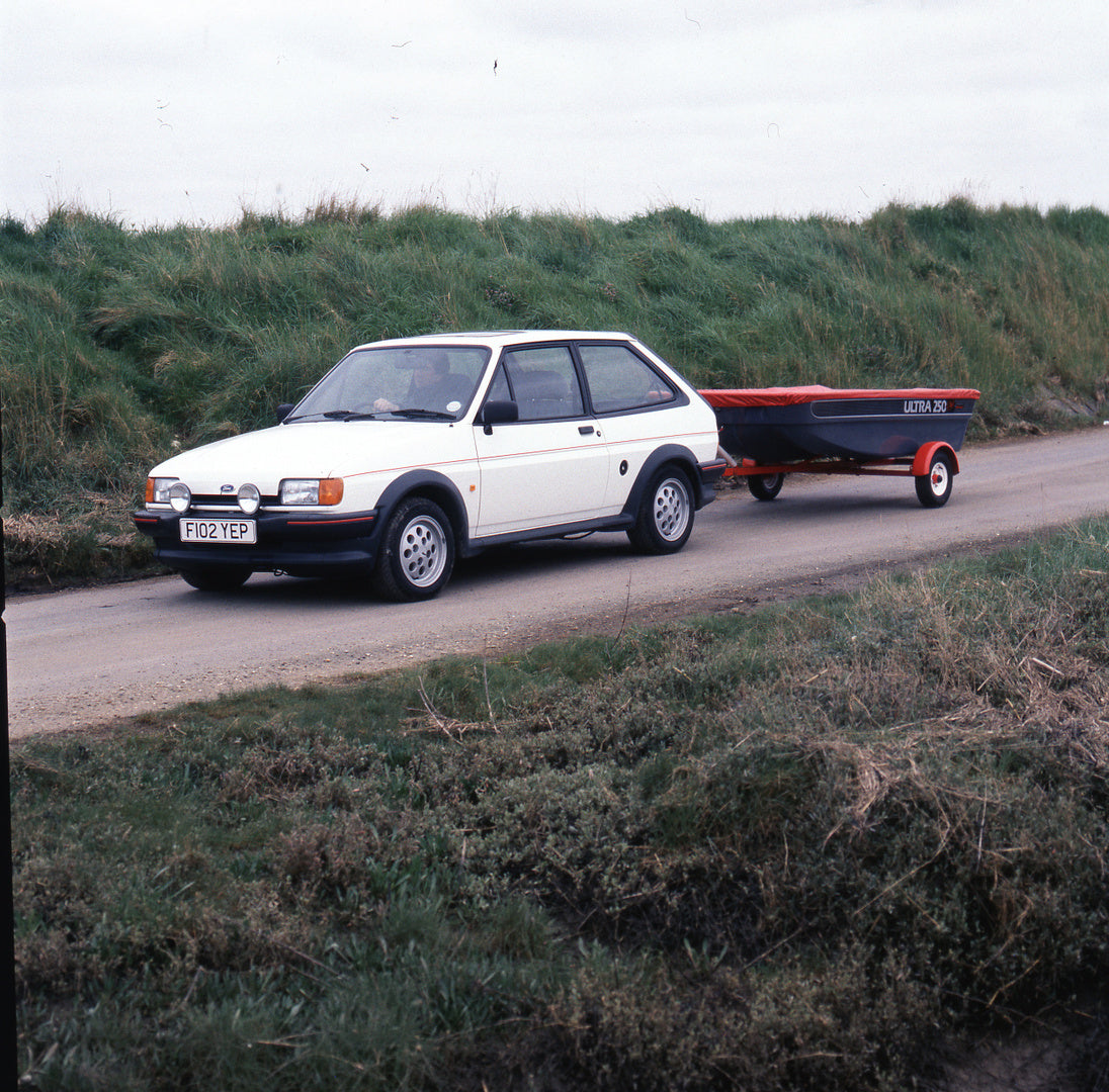 This archival image documents the 1988 Ford Fiesta Mark II XR2 on scenic road with boat trailer and is preserved in the Ford Heritage Vault as part of Ford Motor Company's historic photographic archive. Free for personal, non-commercial use. Ford ...