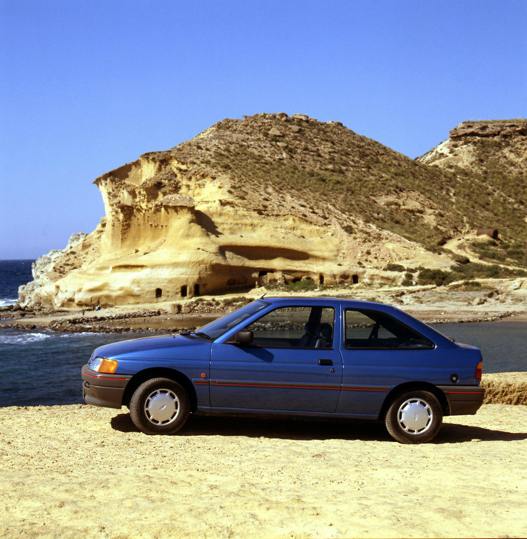 This archival image documents the 1990 Ford Escort CE-14 LHD on beach in Spain and is preserved in the Ford Heritage Vault as part of Ford Motor Company's historic photographic archive. Free for personal, non-commercial use. Ford Heritage Vault re...