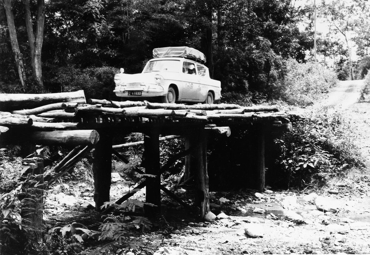 This archival image documents the 1961 Ford Anglia crossing bridge in Thailand and is preserved in the Ford Heritage Vault as part of Ford Motor Company's historic photographic archive. Free for personal, non-commercial use. Ford Heritage Vault re...