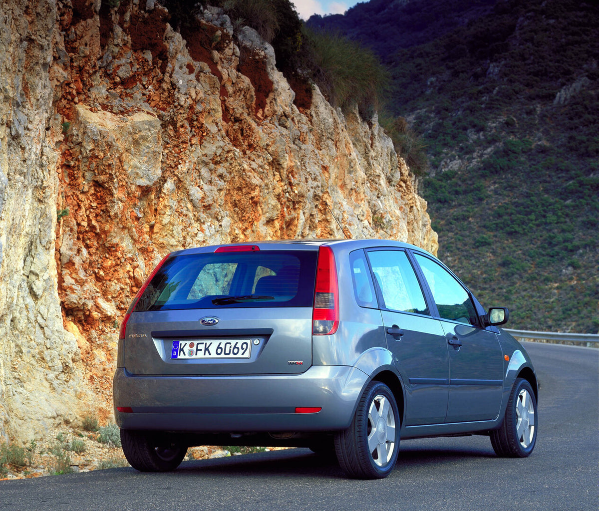 This archival image documents the 2002 Ford Fiesta Mark VI rear view on scenic mountain road and is preserved in the Ford Heritage Vault as part of Ford Motor Company's historic photographic archive. Free for personal, non-commercial use. Ford Her...
