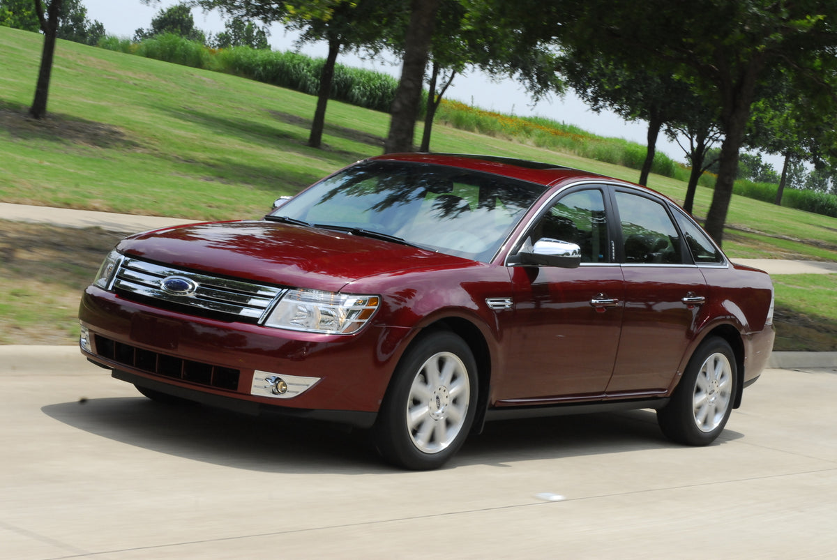 This archival image documents the 2010 Ford Taurus action shot on scenic road and is preserved in the Ford Heritage Vault as part of Ford Motor Company's historic photographic archive. Free for personal, non-commercial use. Ford Heritage Vault ref...