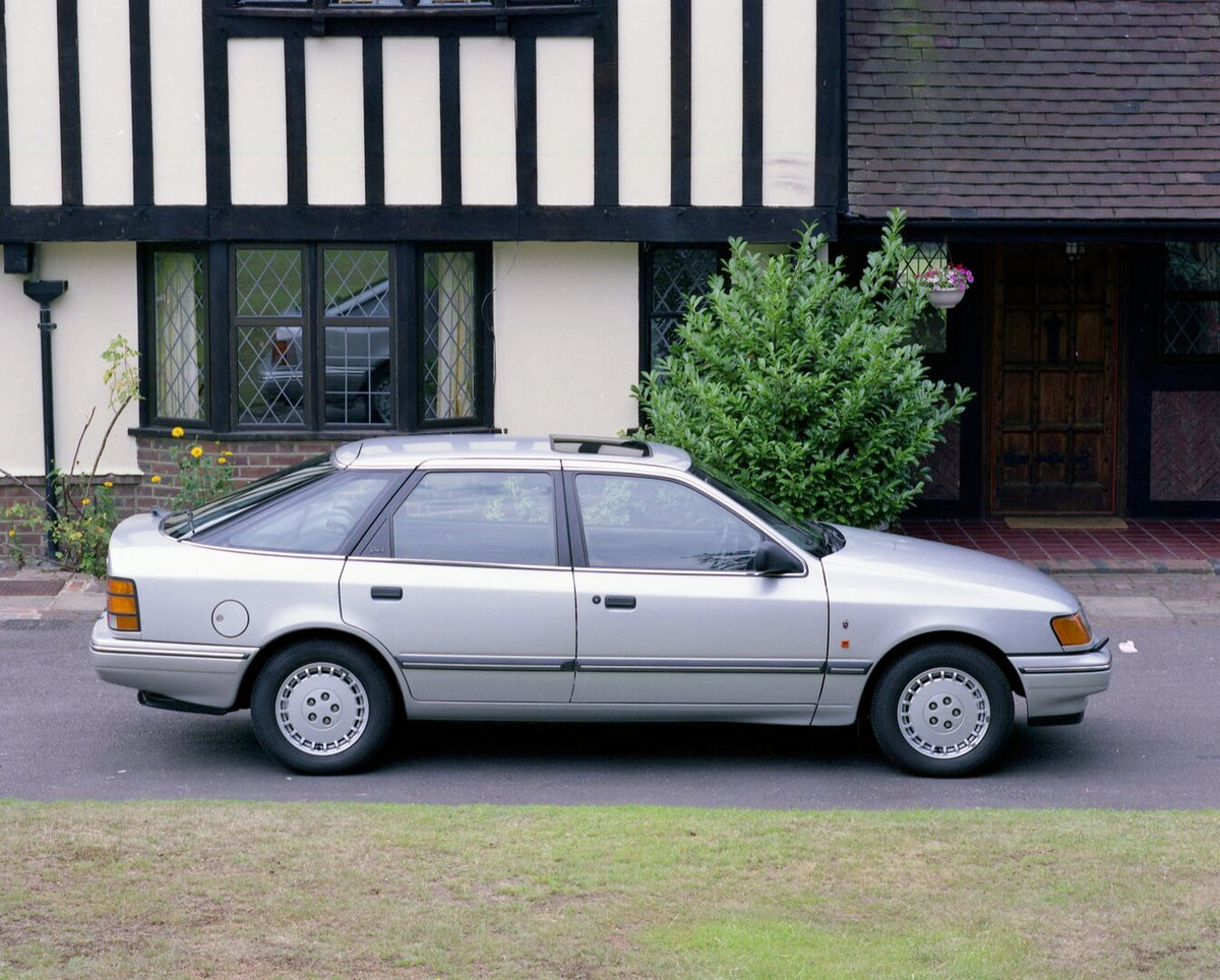 This archival image documents the 1990 Ford Granada MK III Ghia X side view in front of scenic house and is preserved in the Ford Heritage Vault as part of Ford Motor Company's historic photographic archive. Free for personal, non-commercial use. ...