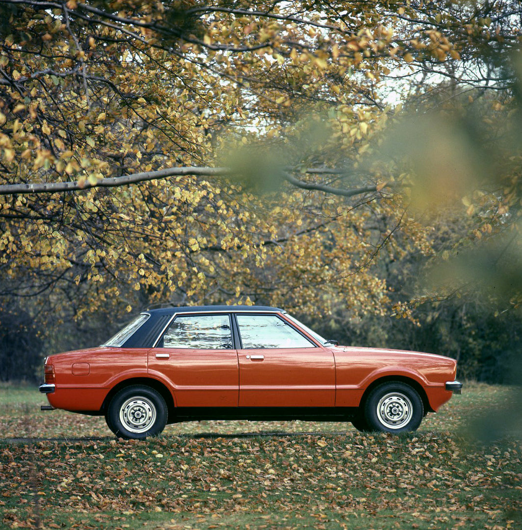 This archival image documents the 1975 Ford Taunus L side view on scenic road with trees and is preserved in the Ford Heritage Vault as part of Ford Motor Company's historic photographic archive. Free for personal, non-commercial use. Ford Heritag...