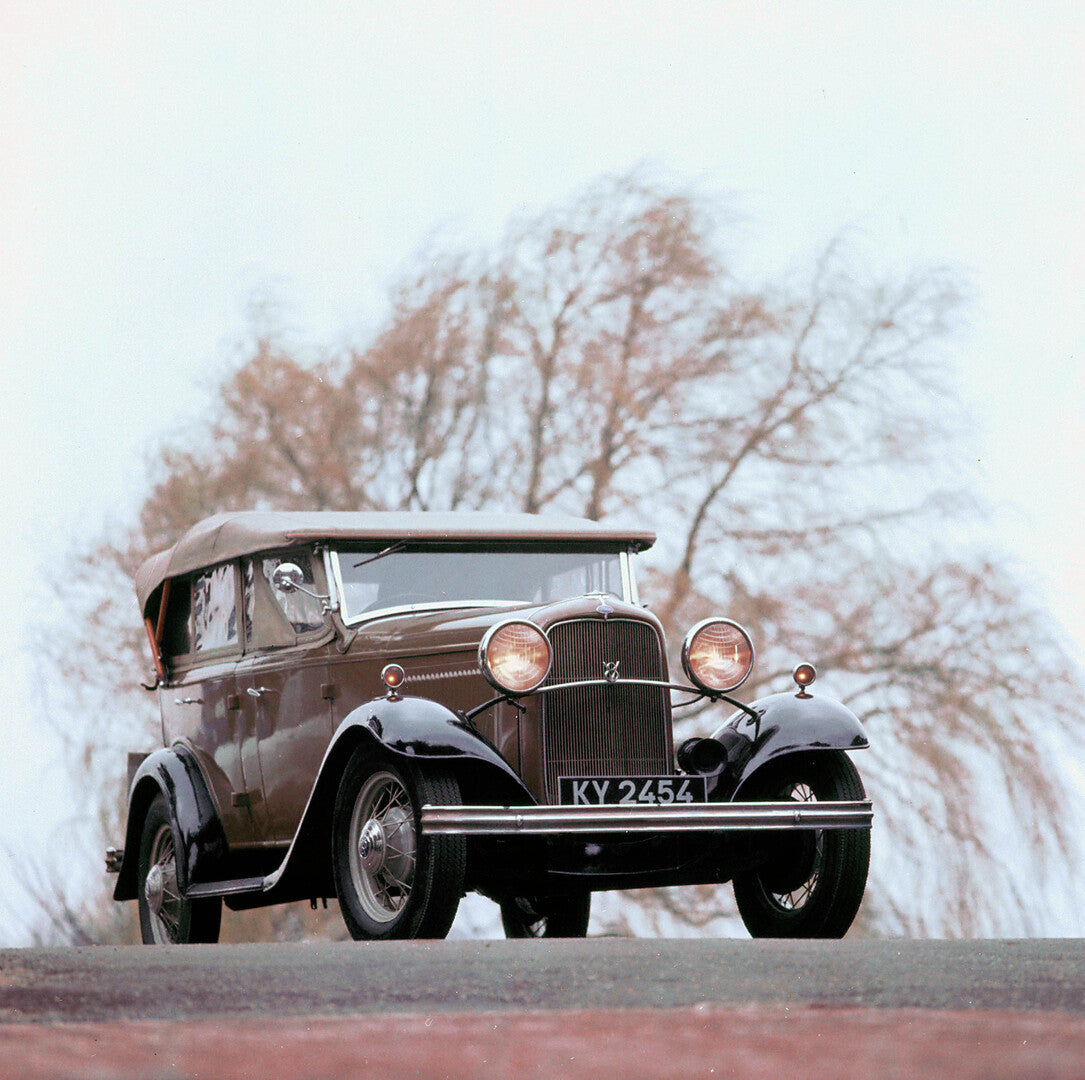 This archival image documents the 1934 Ford V8 sedan front view on road and is preserved in the Ford Heritage Vault as part of Ford Motor Company's historic photographic archive. Free for personal, non-commercial use. Ford Heritage Vault reference...