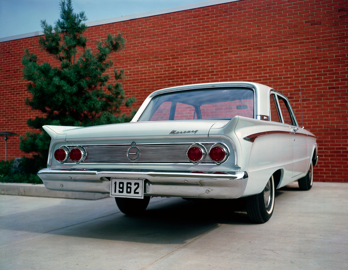 This archival image documents the 1962 Mercury Comet two-door sedan from Back Angle with Red Wall in Background and is preserved in the Ford Heritage Vault as part of Ford Motor Company's historic photographic archive. Free for personal, non-comme...