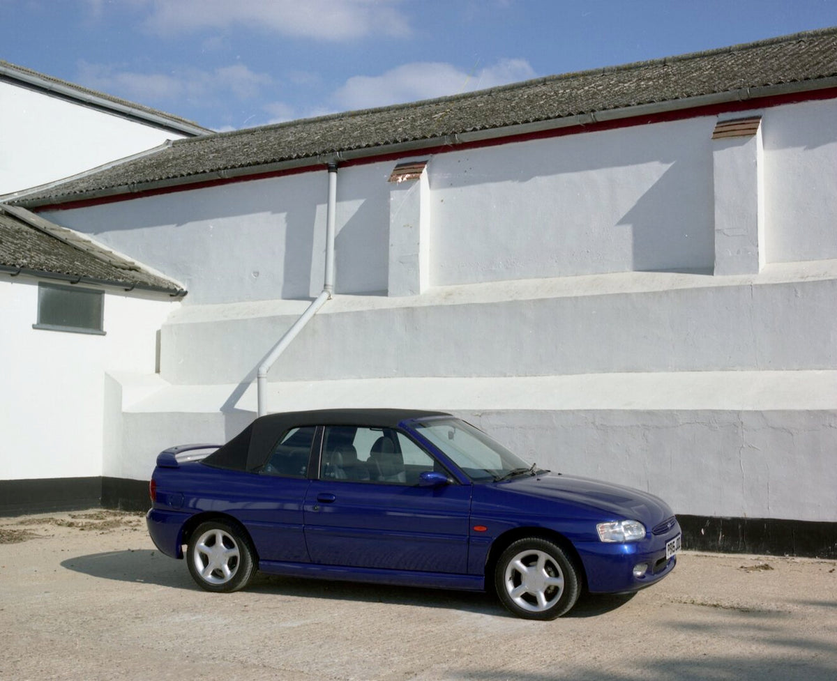 This archival image documents the 1996 Ford Escort Mark VI Cabriolet Ghia front of building with top up and is preserved in the Ford Heritage Vault as part of Ford Motor Company's historic photographic archive. Free for personal, non-commercial us...