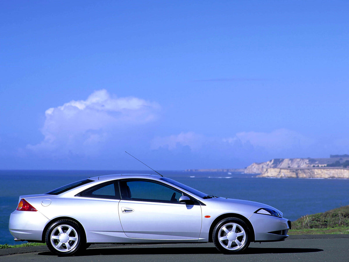 This archival image documents the 2000 Ford Cougar side view scenic and is preserved in the Ford Heritage Vault as part of Ford Motor Company's historic photographic archive. Free for personal, non-commercial use. Ford Heritage Vault reference AR-...