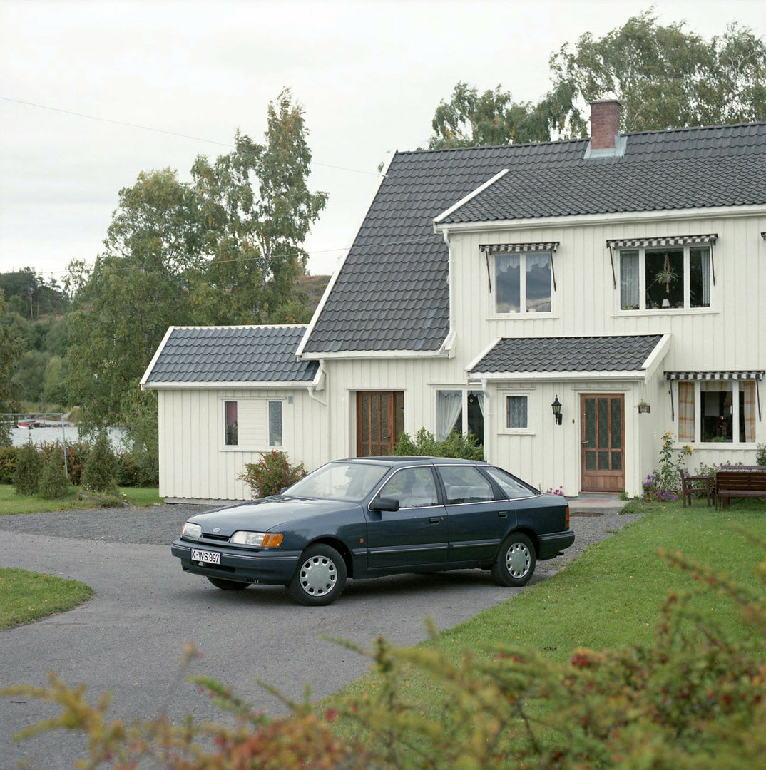 This archival image documents the 1984 Ford Scorpio Mark I GL LHD in front of scenic house in Norway and is preserved in the Ford Heritage Vault as part of Ford Motor Company's historic photographic archive. Free for personal, non-commercial use. ...