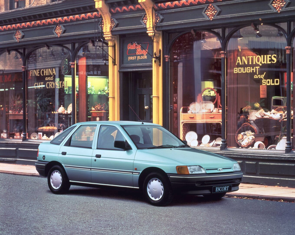 This archival image documents the 1990 Ford Escort Mark V GLX in front of antique shop and is preserved in the Ford Heritage Vault as part of Ford Motor Company's historic photographic archive. Free for personal, non-commercial use. Ford Heritage ...