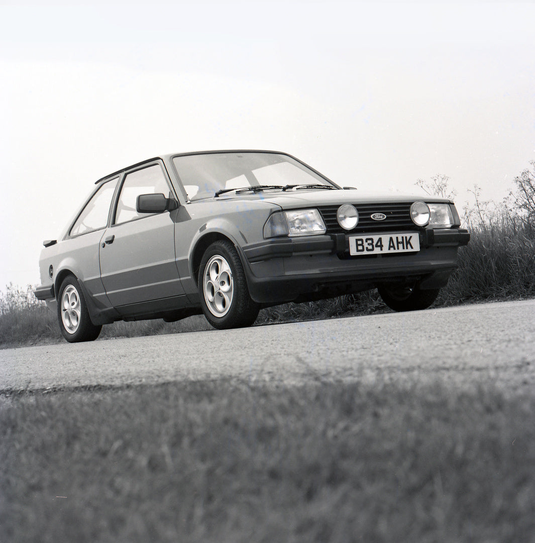 This archival image documents the 1985 Ford Escort Mark III XR3i low view on scenic road and is preserved in the Ford Heritage Vault as part of Ford Motor Company's historic photographic archive. Free for personal, non-commercial use. Ford Heritag...