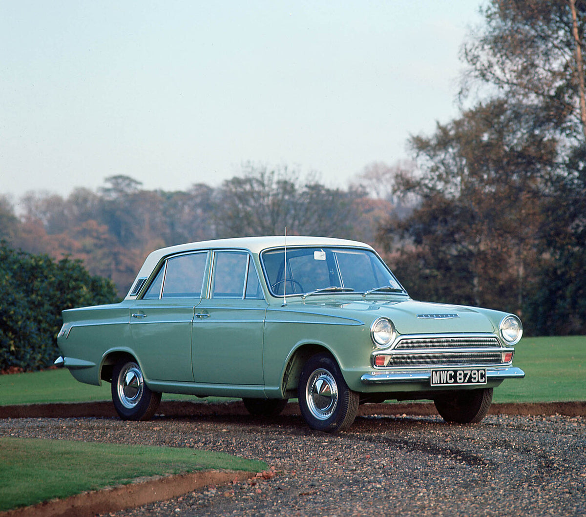 This archival image documents the 1964 Ford Cortina Super Mark I on scenic road with trees and is preserved in the Ford Heritage Vault as part of Ford Motor Company's historic photographic archive. Free for personal, non-commercial use. Ford Herit...