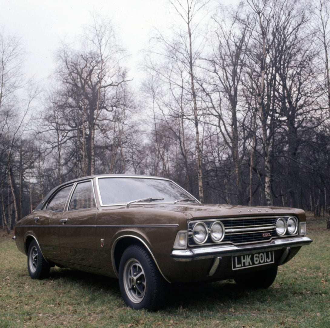 This archival image documents the 1971 Ford Cortina MK III GXL in scenic field with trees and is preserved in the Ford Heritage Vault as part of Ford Motor Company's historic photographic archive. Free for personal, non-commercial use. Ford Herita...