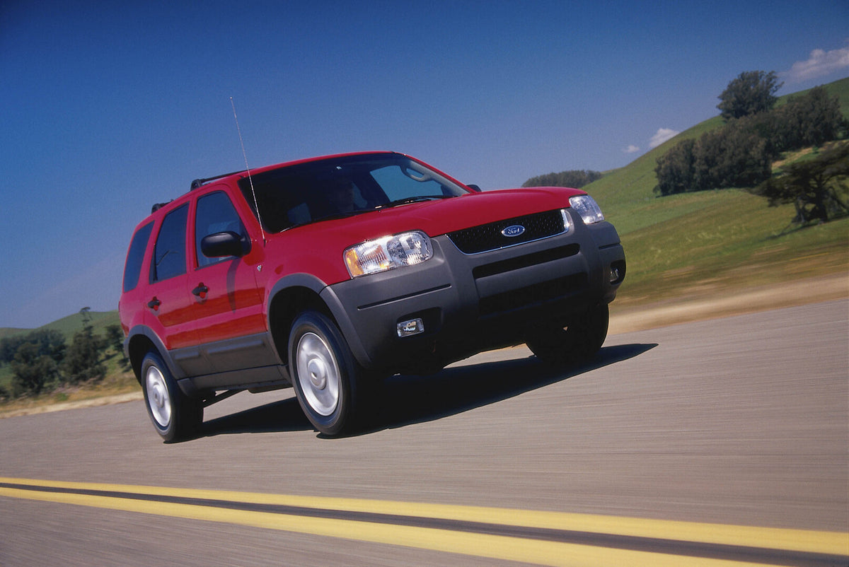 This archival image documents the 2003 Ford Maverick action shot on scenic road and is preserved in the Ford Heritage Vault as part of Ford Motor Company's historic photographic archive. Free for personal, non-commercial use. Ford Heritage Vault r...