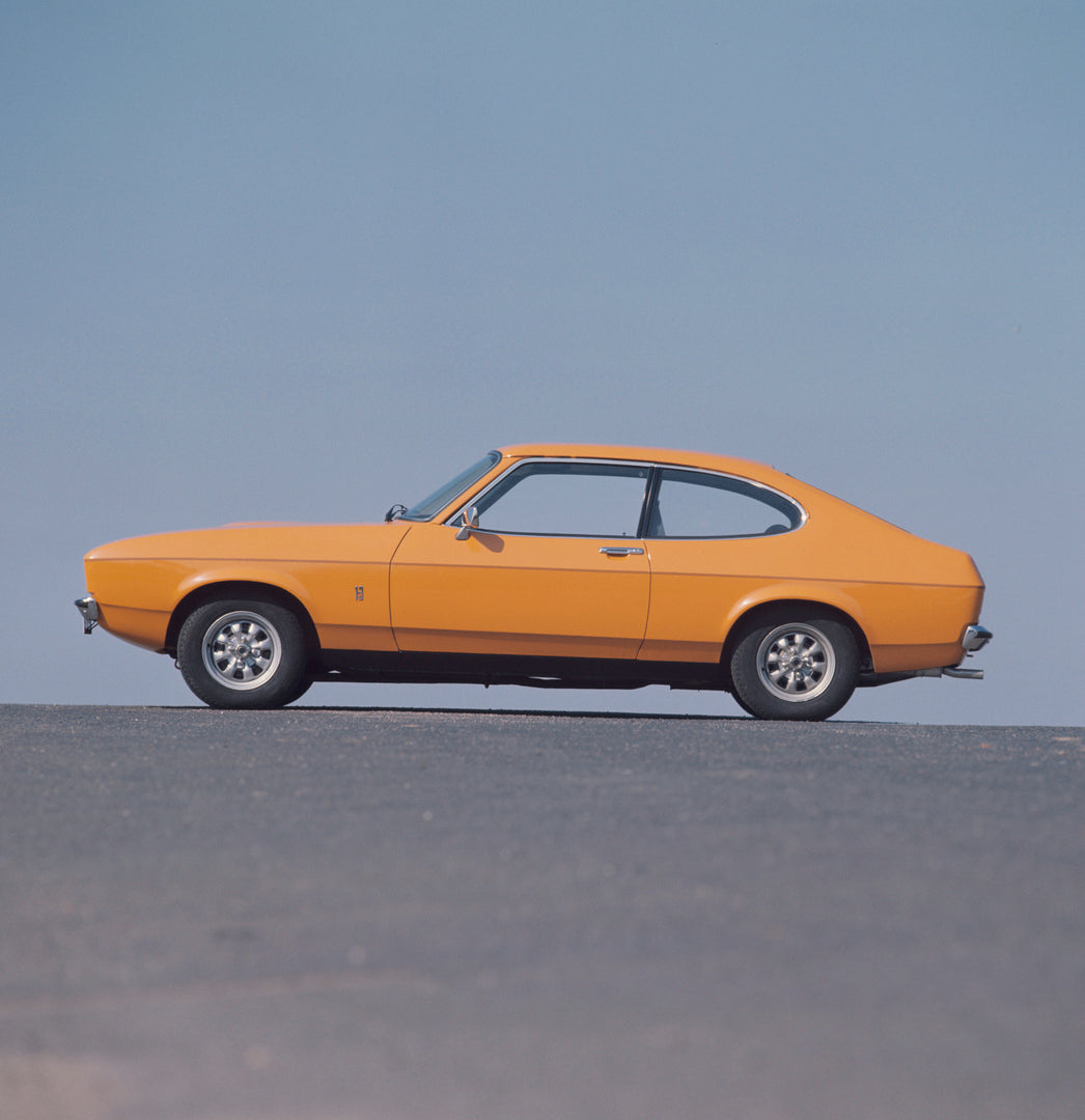 This archival image documents the 1976 Ford Capri II side view with scenic blue sky and is preserved in the Ford Heritage Vault as part of Ford Motor Company's historic photographic archive. Free for personal, non-commercial use. Ford Heritage Vau...