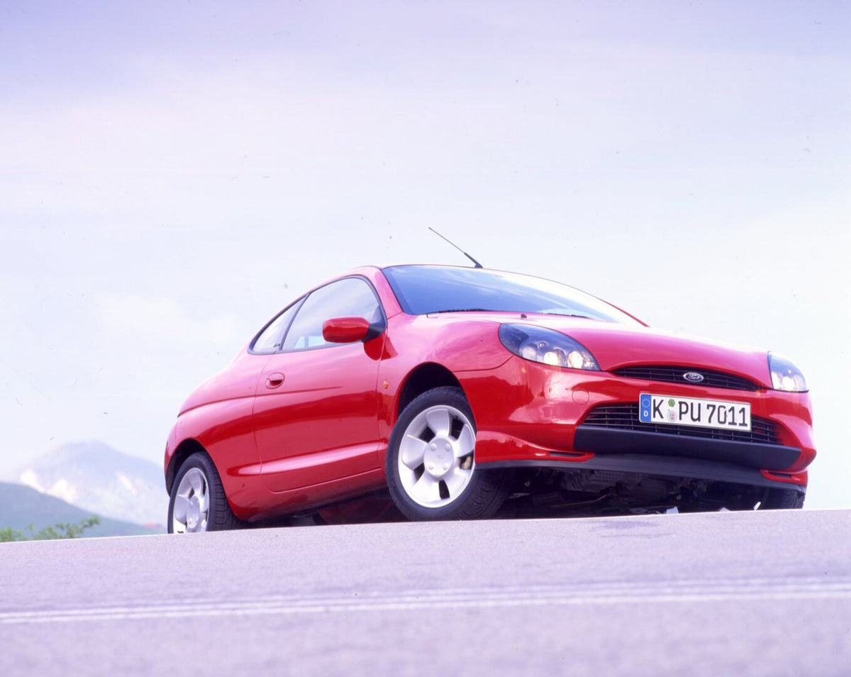 This archival image documents the 1997 Ford Puma LHD on scenic road with mountains in Germany and is preserved in the Ford Heritage Vault as part of Ford Motor Company's historic photographic archive. Free for personal, non-commercial use. Ford He...