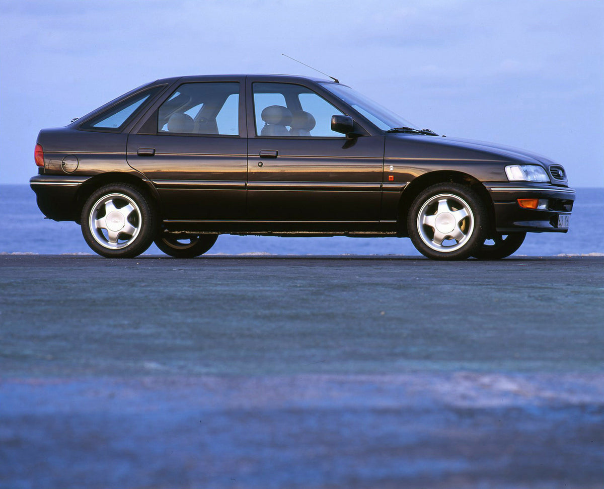 This archival image documents the 1994 Ford Escort Mark V Ghia Si side view on pavement and is preserved in the Ford Heritage Vault as part of Ford Motor Company's historic photographic archive. Free for personal, non-commercial use. Ford Heritage...