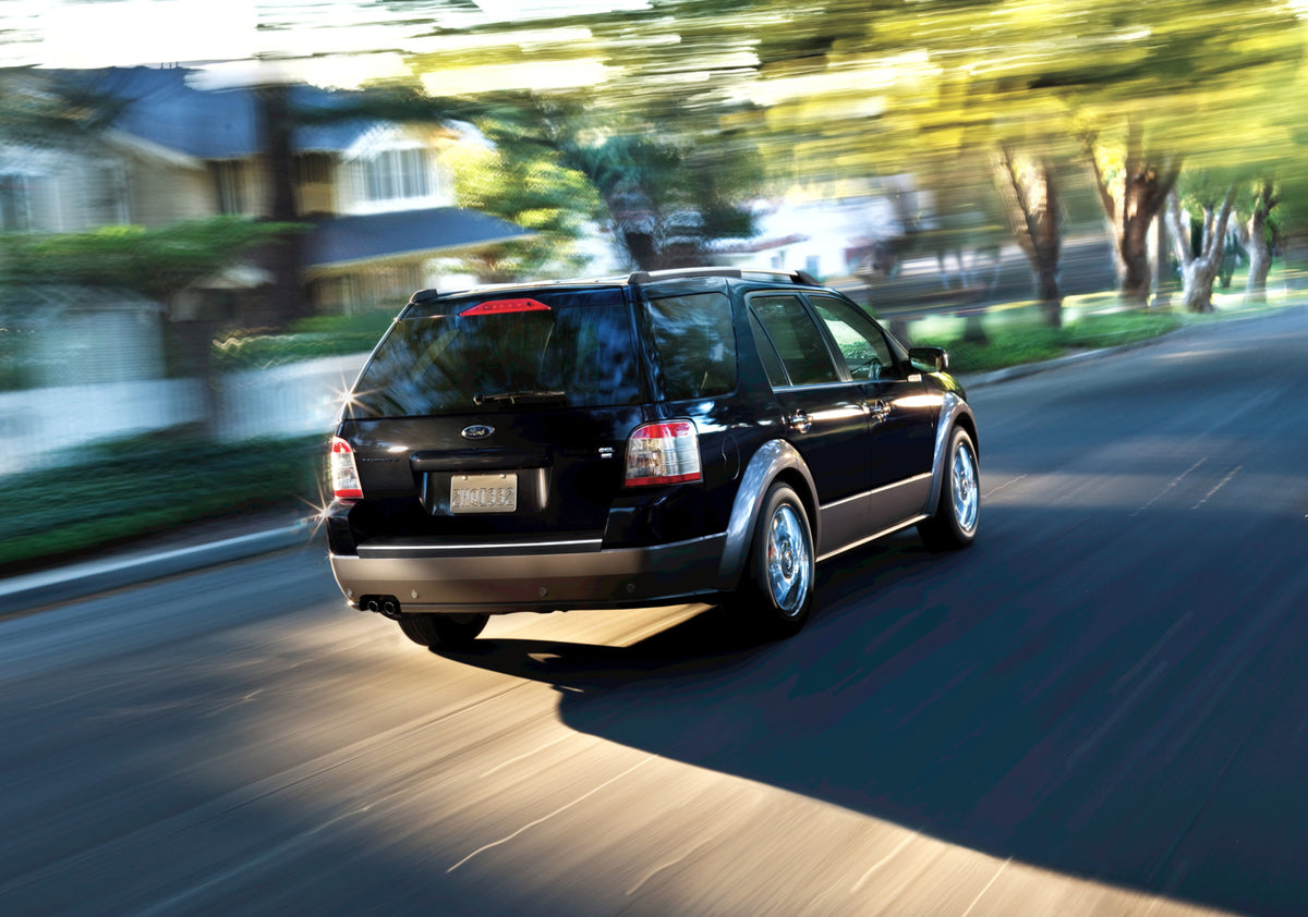 This archival image documents the 2009 Ford Taurus X action shot on scenic street MS77707335 and is preserved in the Ford Heritage Vault as part of Ford Motor Company's historic photographic archive. Free for personal, non-commercial use. Ford Her...
