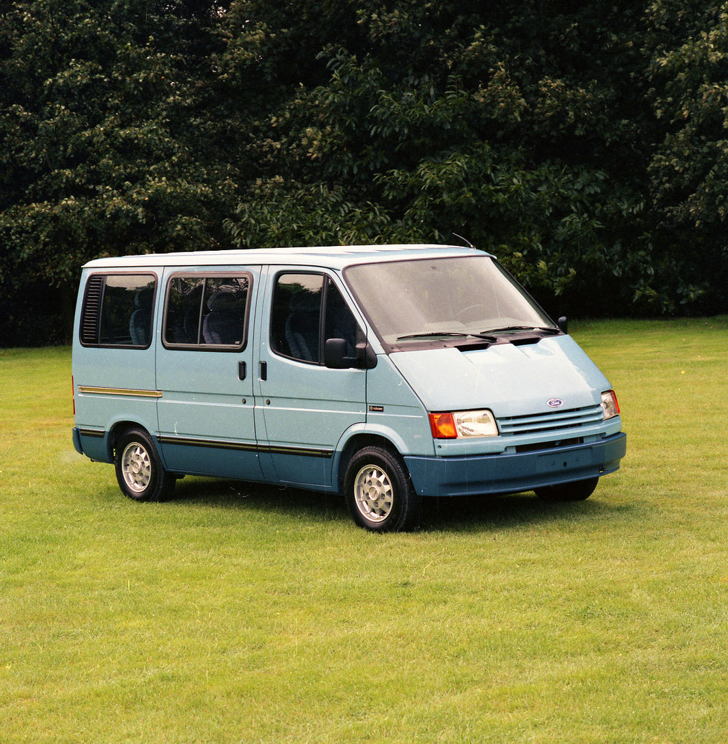 This archival image documents the 1988 Ford Transit Mark III Ghia Bus in scenic field with trees and is preserved in the Ford Heritage Vault as part of Ford Motor Company's historic photographic archive. Free for personal, non-commercial use. Ford...