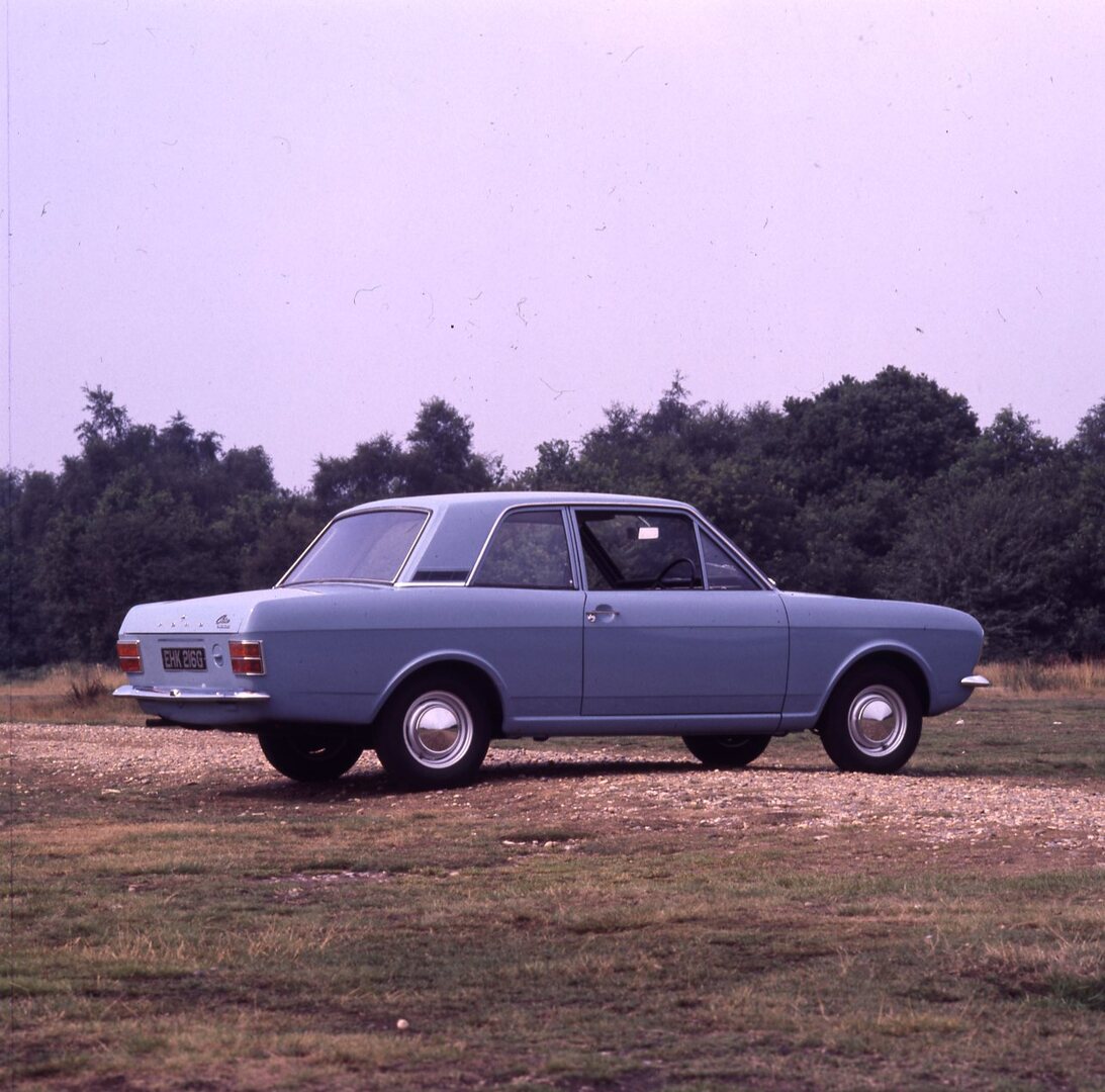 This archival image documents the 1969 Ford Cortina MK II DL 1300 2 door rear view in scenic field with trees and is preserved in the Ford Heritage Vault as part of Ford Motor Company's historic photographic archive. Free for personal, non-commerc...