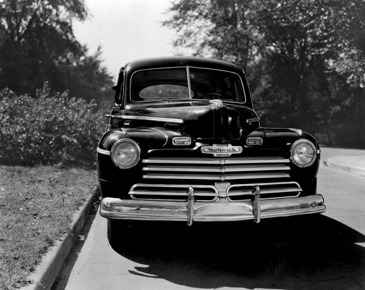 This archival image documents the 1946 Monarch Sedan front view on scenic road with trees AR-2007-5 and is preserved in the Ford Heritage Vault as part of Ford Motor Company's historic photographic archive. Free for personal, non-commercial use. F...