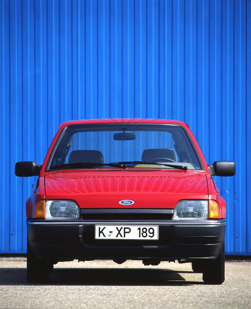 This archival image documents the 1989 Heritage Archive - 1988 Ford Escort Mark IV front view in front of blue wall and is preserved in the Ford Heritage Vault as part of Ford Motor Company's historic photographic archive. Free for personal, non-c...