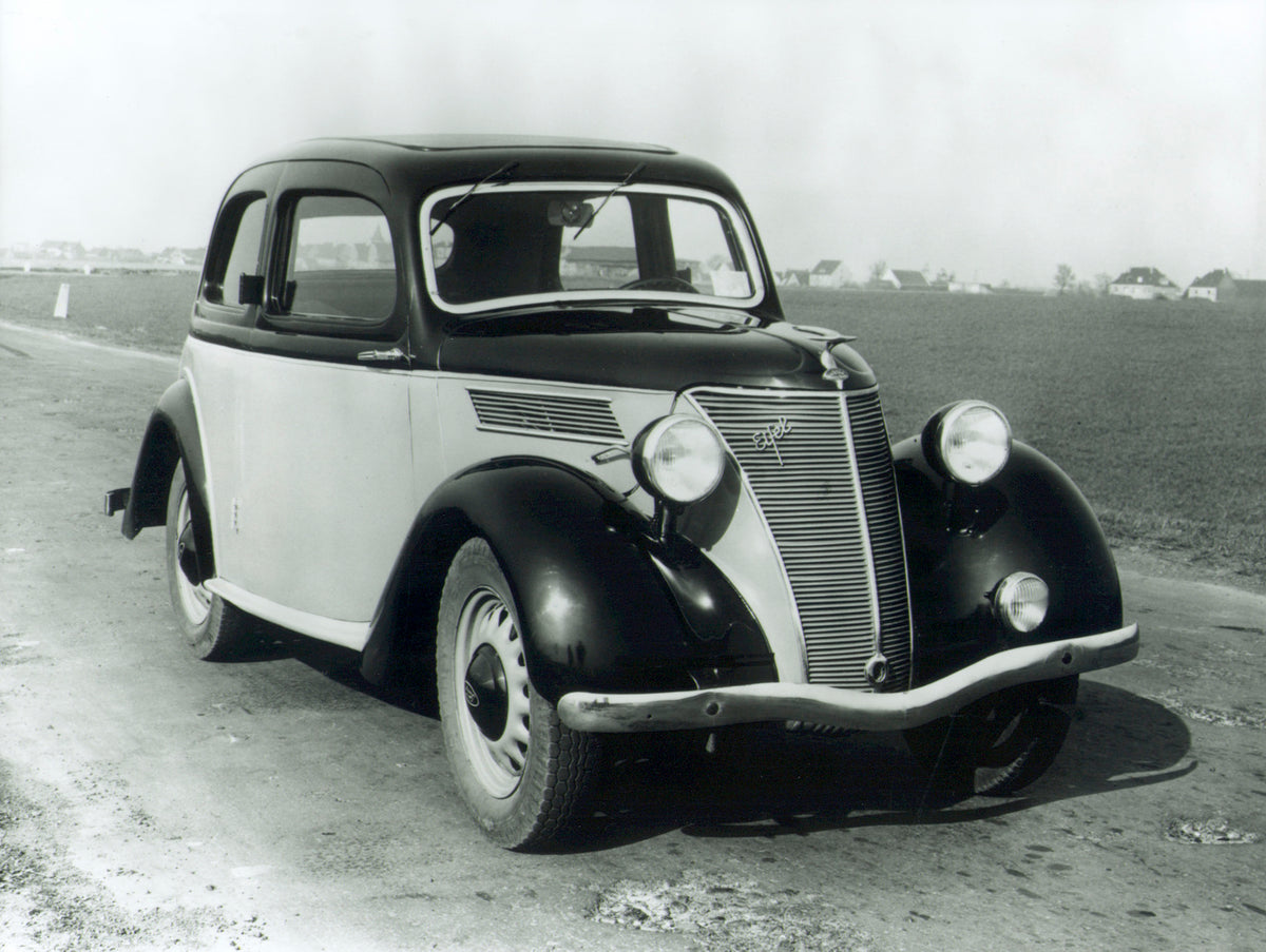 This archival image documents the 1936 Ford Eifel on scenic road and is preserved in the Ford Heritage Vault as part of Ford Motor Company's historic photographic archive. Free for personal, non-commercial use. Ford Heritage Vault reference AR-200...