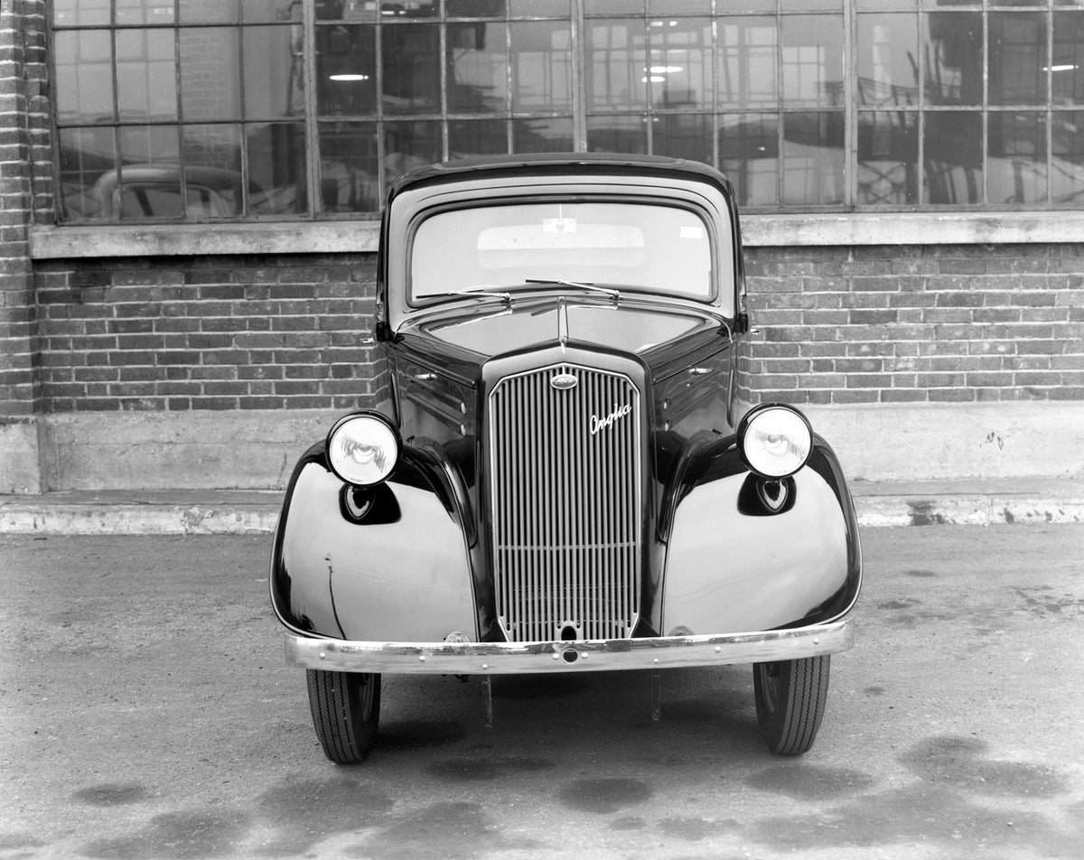 This archival image documents the 1946 Ford Anglia E04A front view and is preserved in the Ford Heritage Vault as part of Ford Motor Company's historic photographic archive. Free for personal, non-commercial use. Ford Heritage Vault reference AR-2...