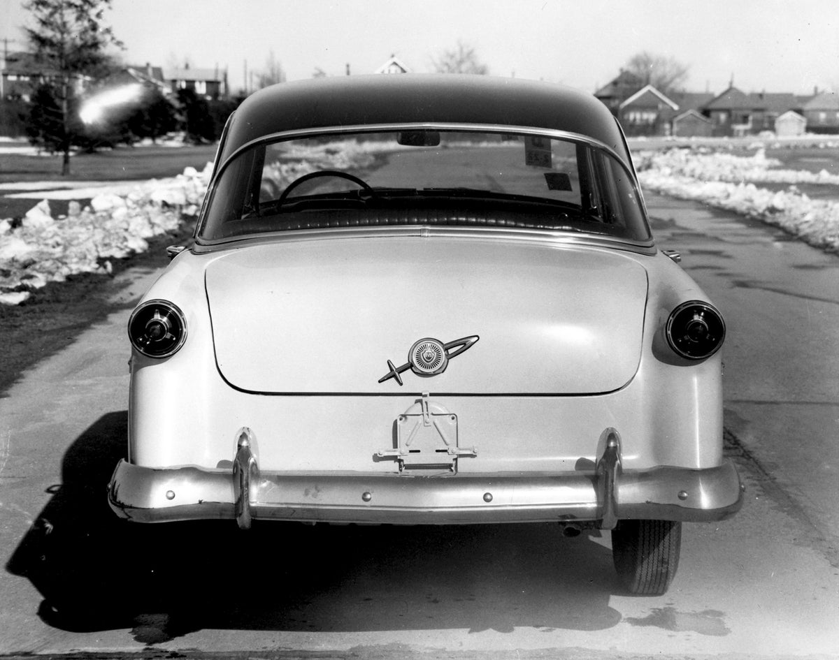 This archival image documents the 1954 Meteor Mainline Coupe rear view on scenic road AR-2007-5 and is preserved in the Ford Heritage Vault as part of Ford Motor Company's historic photographic archive. Free for personal, non-commercial use. Ford ...