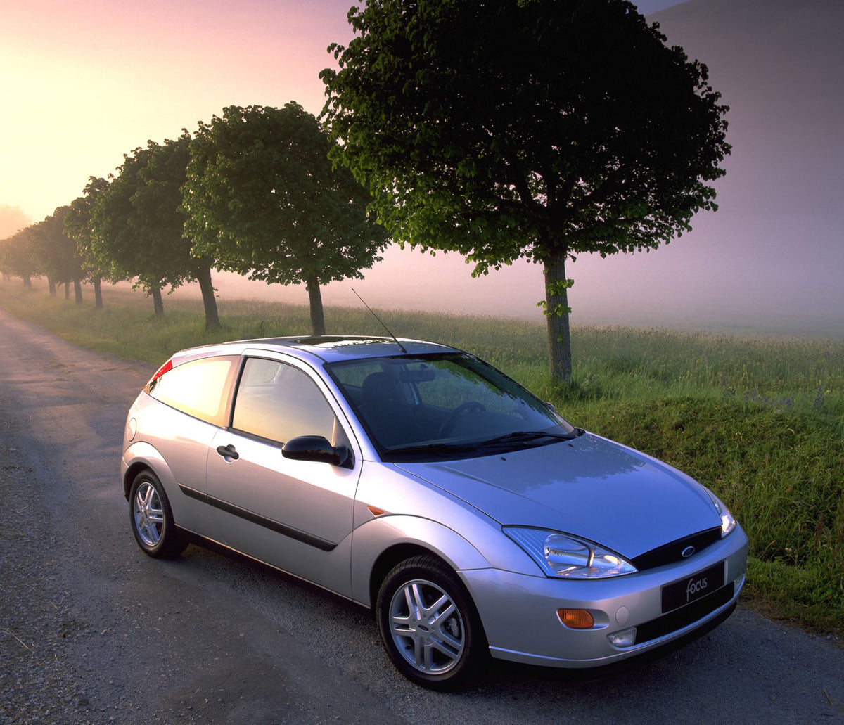 This archival image documents the 1998 Ford Focus on scenic road with trees and is preserved in the Ford Heritage Vault as part of Ford Motor Company's historic photographic archive. Free for personal, non-commercial use. Ford Heritage Vault refer...
