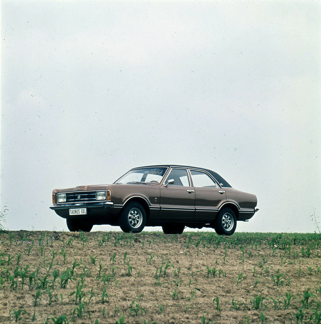 This archival image documents the 1974 Ford Taunus GXL on scenic hill and is preserved in the Ford Heritage Vault as part of Ford Motor Company's historic photographic archive. Free for personal, non-commercial use. Ford Heritage Vault reference A...