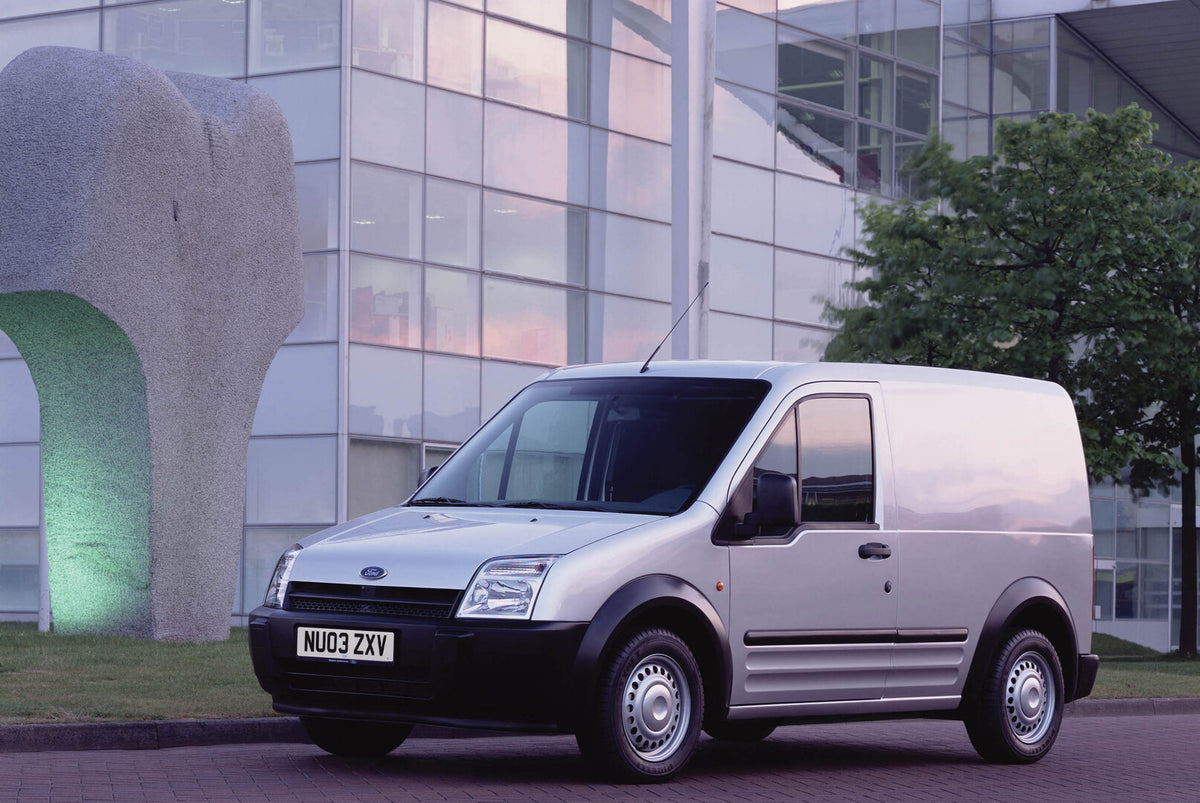 This archival image documents the 2003 Transit Connect in front of scenic building and is preserved in the Ford Heritage Vault as part of Ford Motor Company's historic photographic archive. Free for personal, non-commercial use. Ford Heritage Vaul...