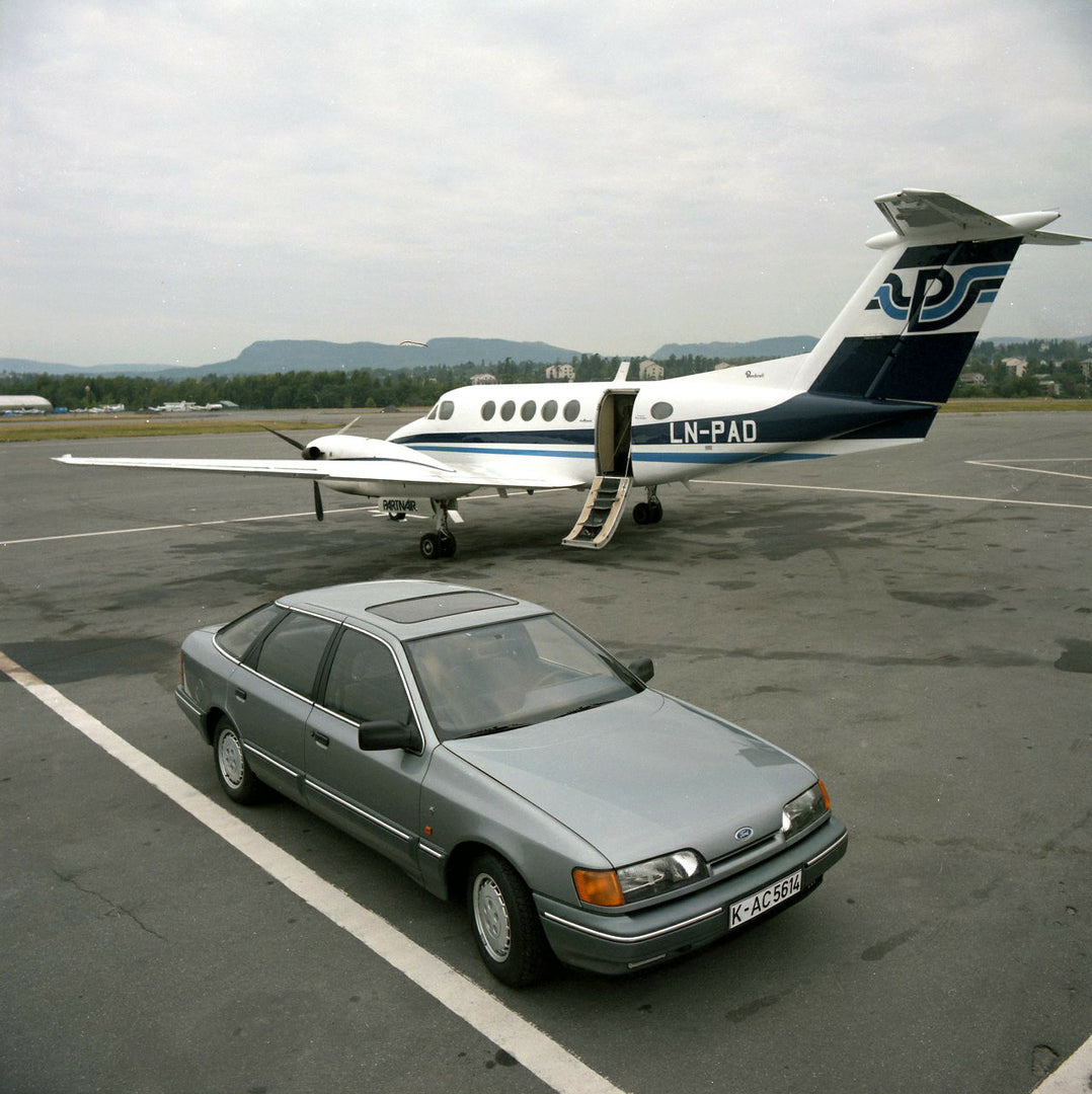 This archival image documents the 1986 Ford Granada Mark III Ghia with plane on tarmac in Norway and is preserved in the Ford Heritage Vault as part of Ford Motor Company's historic photographic archive. Free for personal, non-commercial use. Ford...