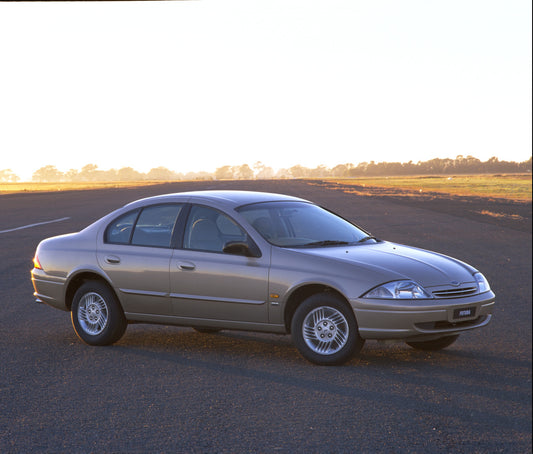 1998 Ford Falcon Futura on scenic road with trees HV 1998-0072