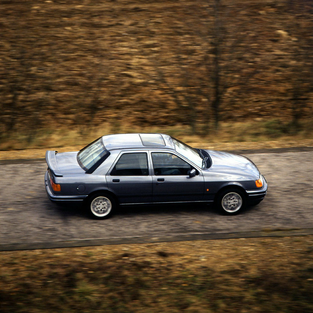 This archival image documents the 1987 Ford Sierra Cosworth LHD aerial view action shot on scenic road and is preserved in the Ford Heritage Vault as part of Ford Motor Company's historic photographic archive. Free for personal, non-commercial use...