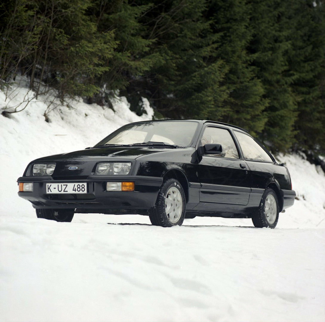 This archival image documents the 1985 Ford Sierra XR 4x4 LHD low view on scenic snowy road and is preserved in the Ford Heritage Vault as part of Ford Motor Company's historic photographic archive. Free for personal, non-commercial use. Ford Heri...