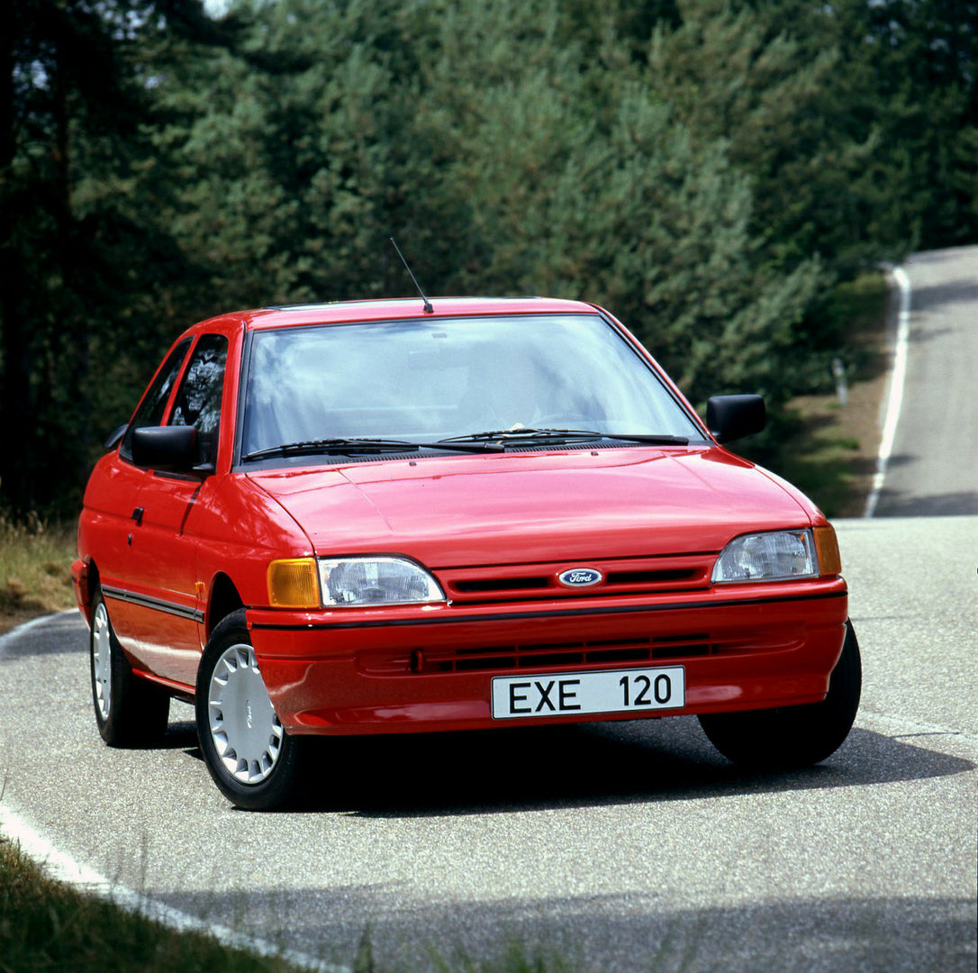 This archival image documents the 1990 Ford Escort S Mark IV on road in Lommel, Belgium and is preserved in the Ford Heritage Vault as part of Ford Motor Company's historic photographic archive. Free for personal, non-commercial use. Ford Heritage...