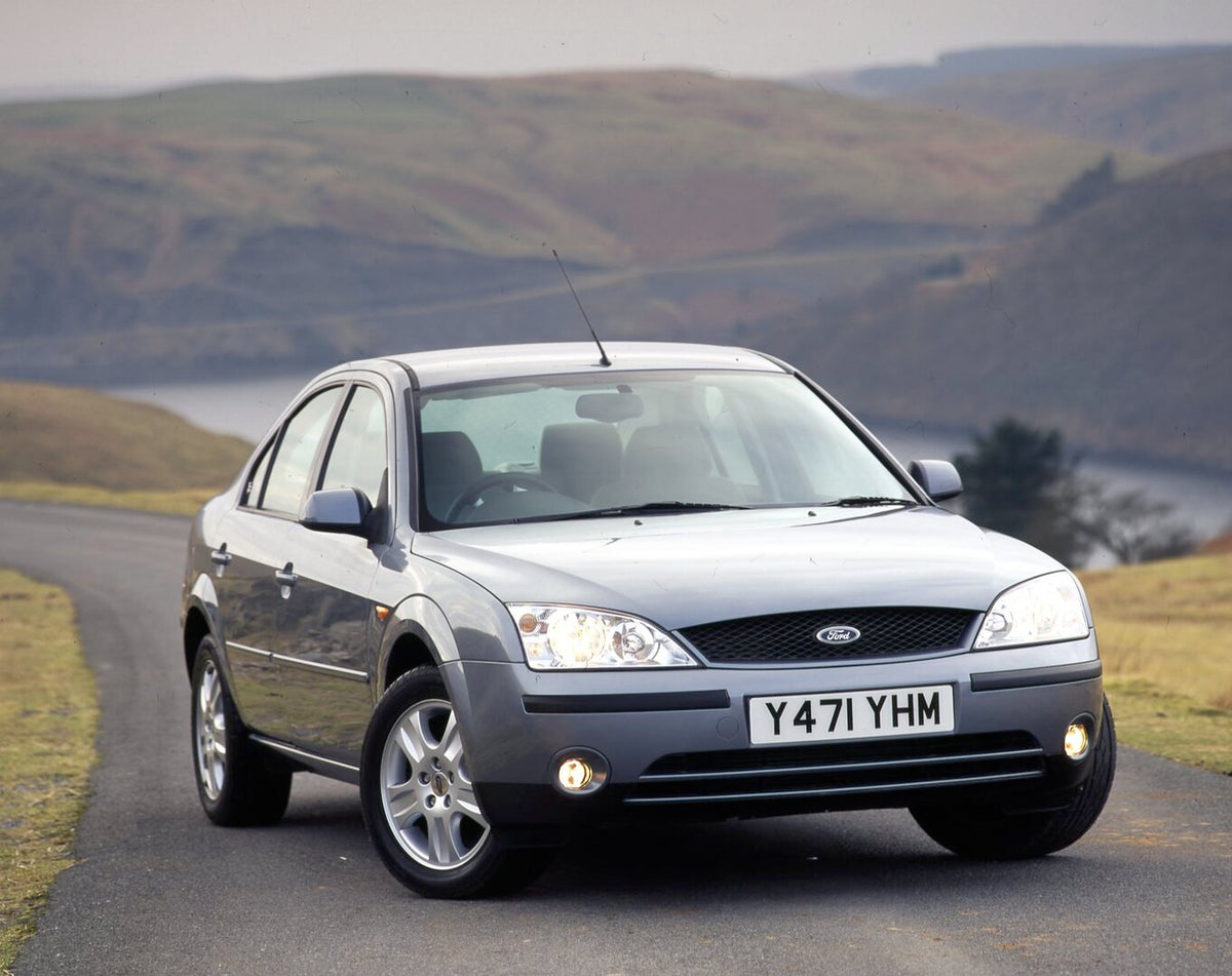 This archival image documents the 2001 Ford Mondeo Mark II Ghia front view on scenic road with lake and is preserved in the Ford Heritage Vault as part of Ford Motor Company's historic photographic archive. Free for personal, non-commercial use. F...