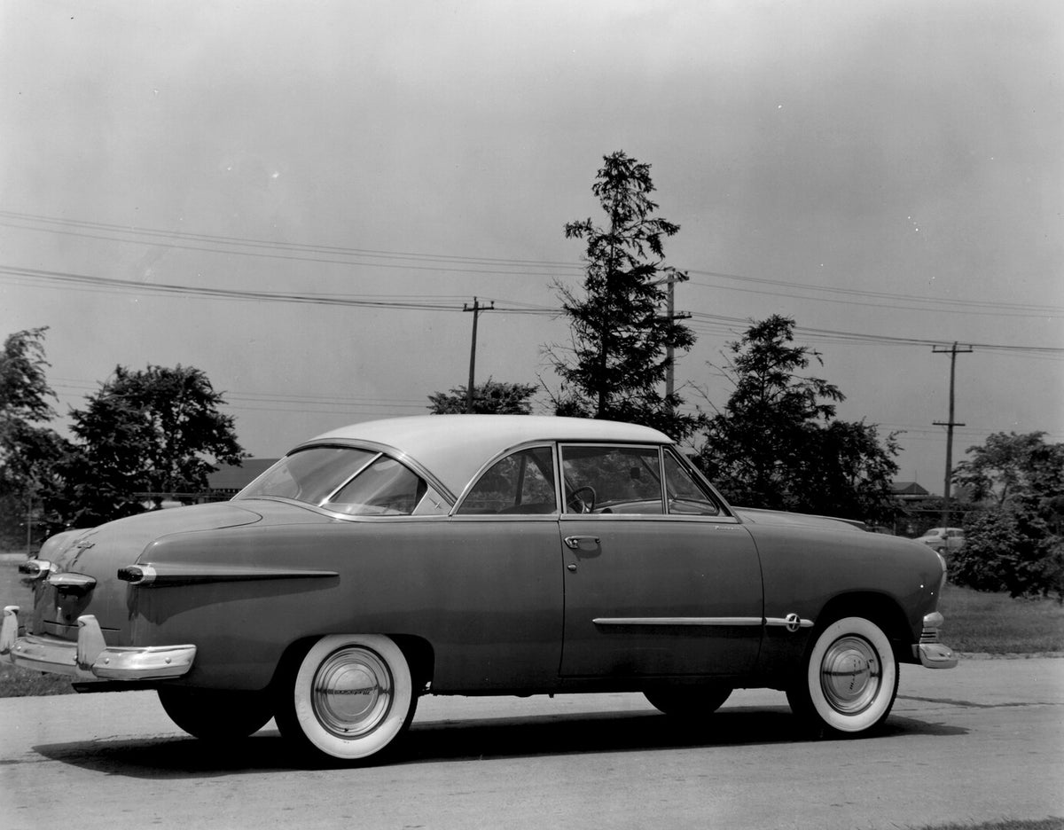This archival image documents the 1951 Meteor Coupe rear view on scenic road with trees AR-2007-5 and is preserved in the Ford Heritage Vault as part of Ford Motor Company's historic photographic archive. Free for personal, non-commercial use. For...