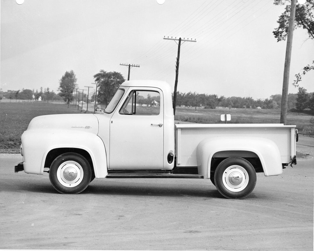 This archival image documents the 1955 Mercury M-100 side view on scenic road with trees and is preserved in the Ford Heritage Vault as part of Ford Motor Company's historic photographic archive. Free for personal, non-commercial use. Ford Heritag...