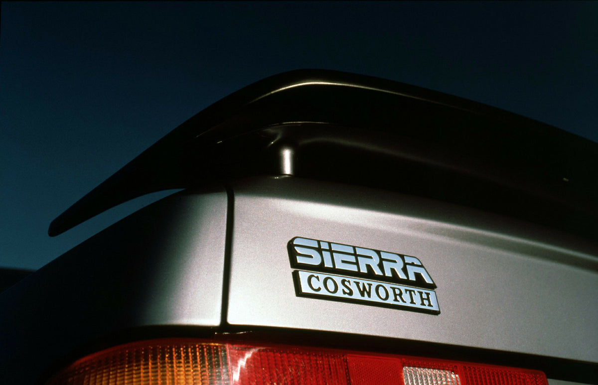 This archival image documents the 1987 Ford Sierra RS Cosworth badge closeup and is preserved in the Ford Heritage Vault as part of Ford Motor Company's historic photographic archive. Free for personal, non-commercial use. Ford Heritage Vault refe...