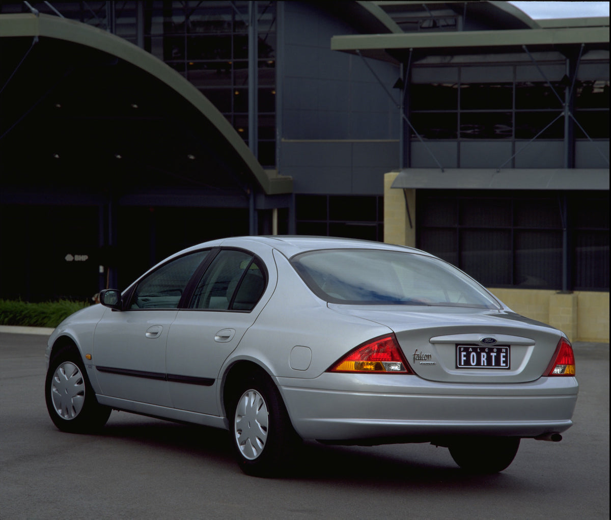 This archival image documents the 1998 Ford Falcon Forte rear view in front of scenic building and is preserved in the Ford Heritage Vault as part of Ford Motor Company's historic photographic archive. Free for personal, non-commercial use. Ford H...