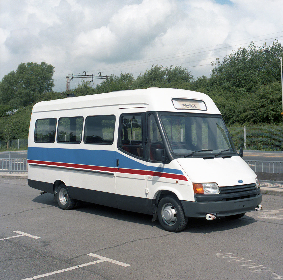 This archival image documents the 1987 Ford Transit Mark III 20 Seat Bus in parking lot with scenic trees and is preserved in the Ford Heritage Vault as part of Ford Motor Company's historic photographic archive. Free for personal, non-commercial ...
