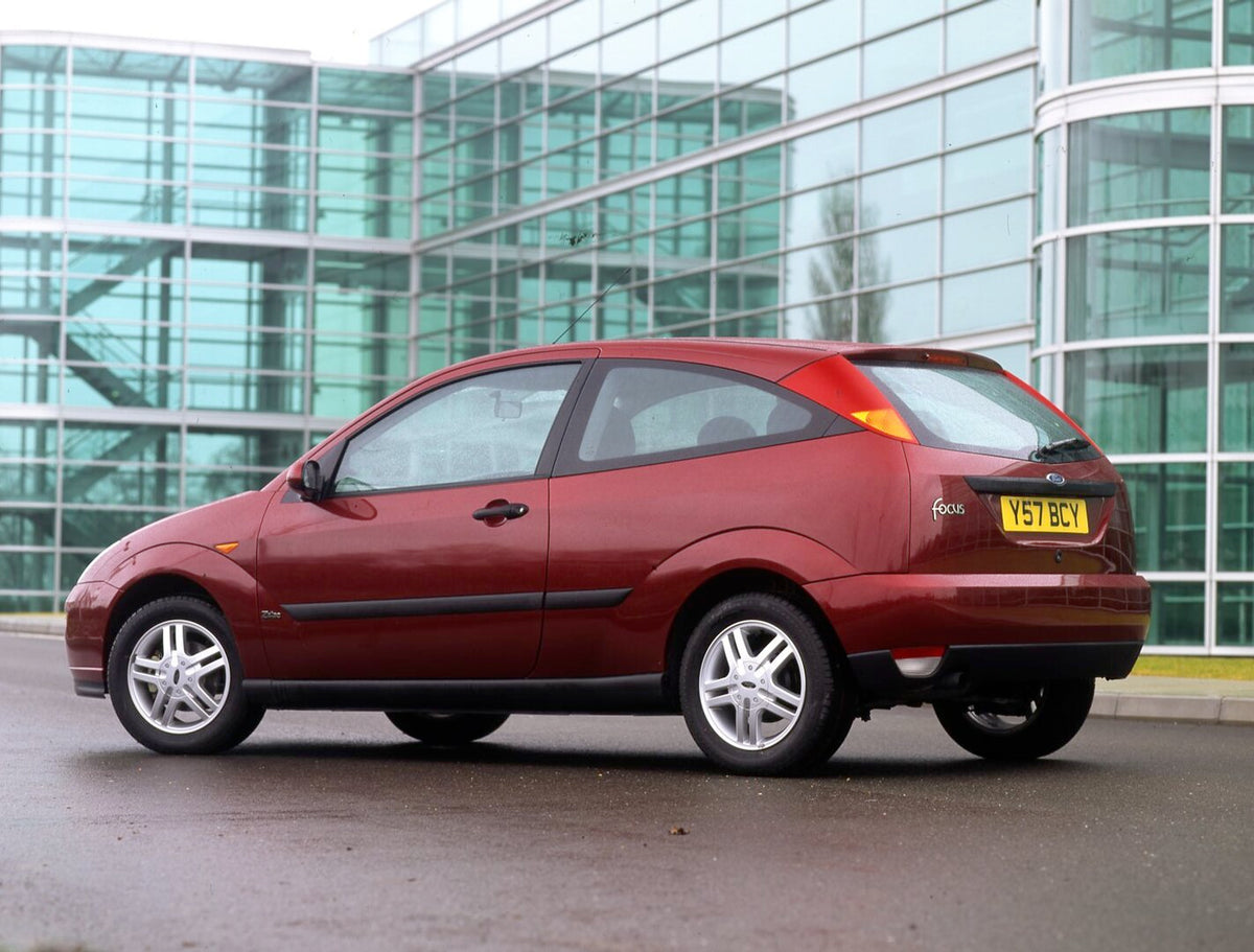 This archival image documents the 2001 Ford Focus Mark I Zetec TDDI rear view in front of scenic glass building and is preserved in the Ford Heritage Vault as part of Ford Motor Company's historic photographic archive. Free for personal, non-comme...